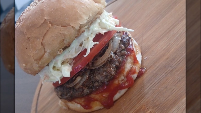 Lebanese burger with cole slaw on wooden board