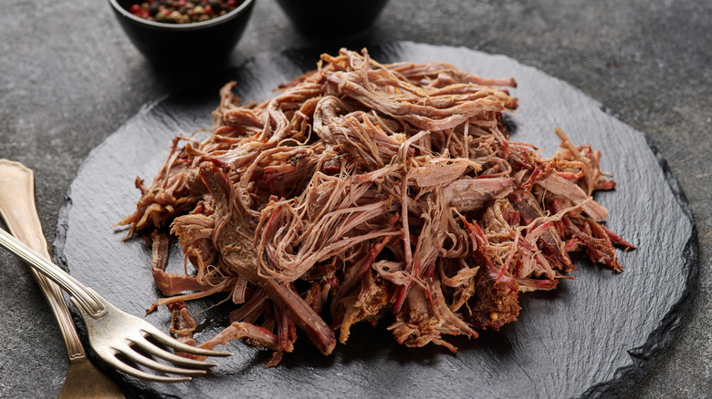 BBQ pulled pork with forks and seasoning