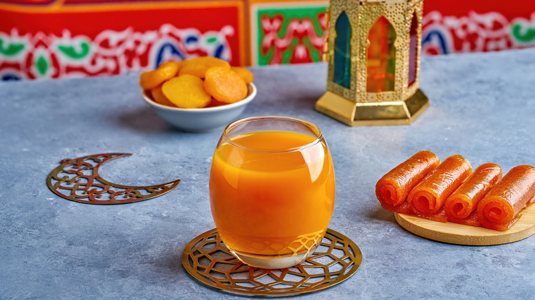 glass of qamar al-din on blue marble surface