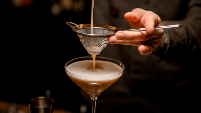 bartender straining espresso martini