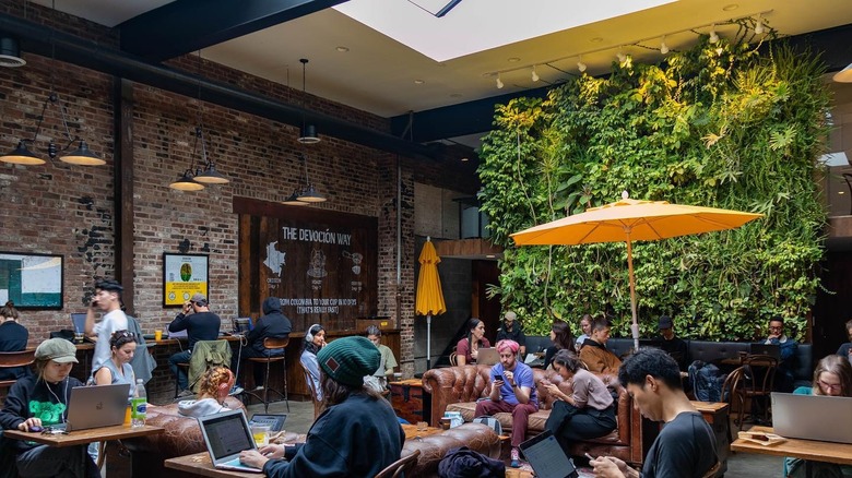 cafe tables people brick plants