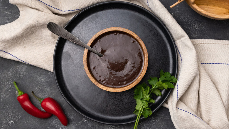 Hoisin sauce on dark plate