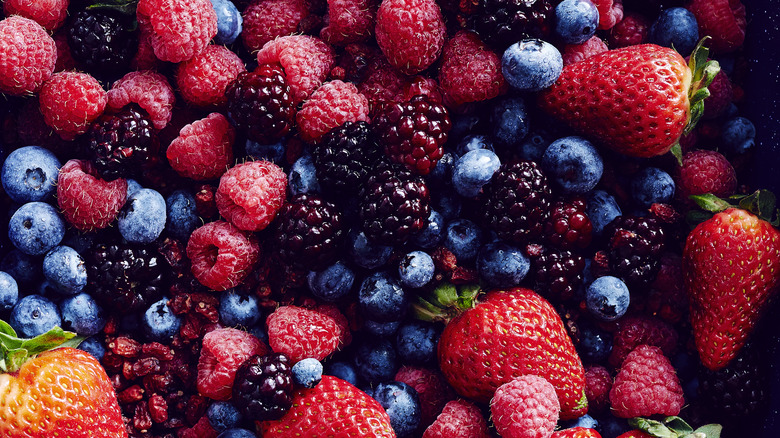 Close up of mixed fresh berries, including strawberries, blueberries, raspberries, and blackberries