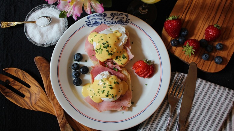 Runny eggs topping ham slices