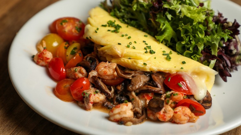 Crawfish-stuffed omelet and greens