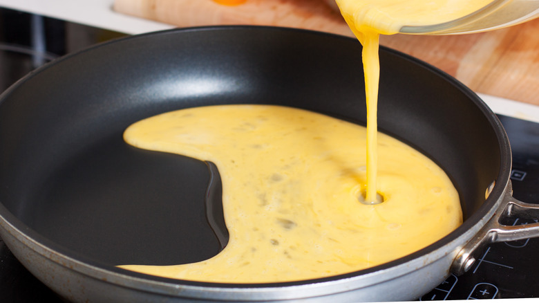 Pouring eggs into pan for egg white wraps