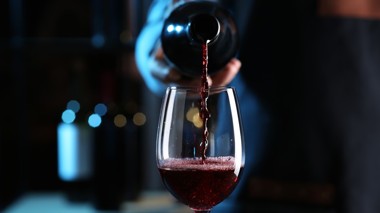 Red wine pouring into glass