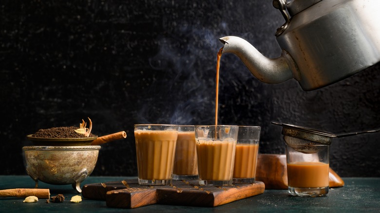 Pouring chai into glasses