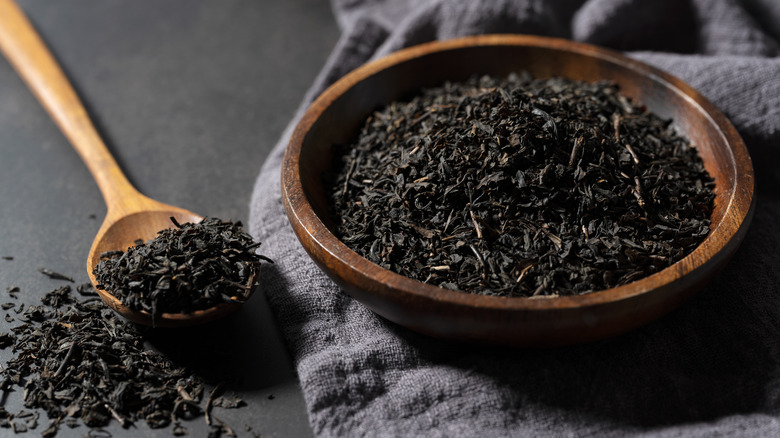 Black tea leaves in a wooden bowl