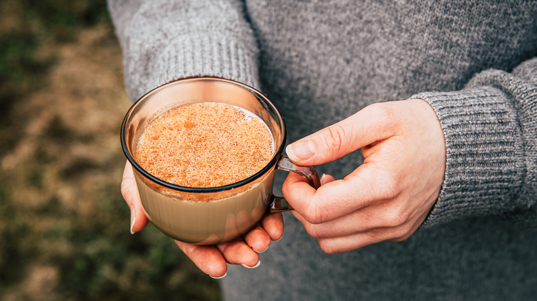 Hands holding a chai mug