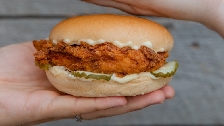 Hand holding chicken sandwich