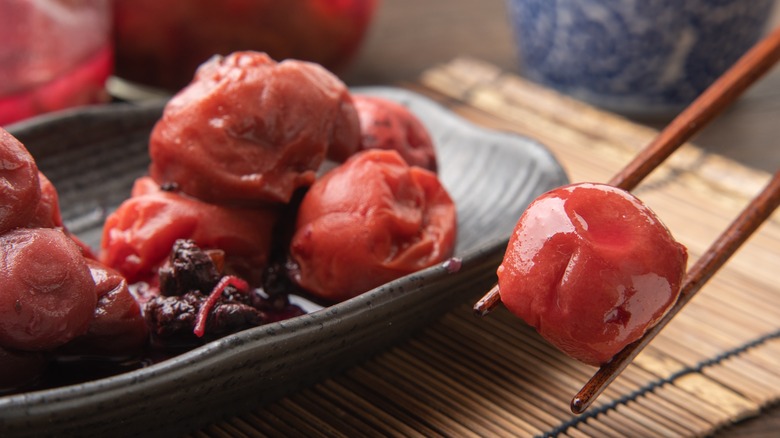 Chopsticks holding umeboshi