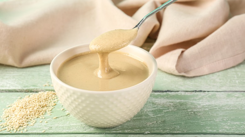 spoonful of tahini over bowl