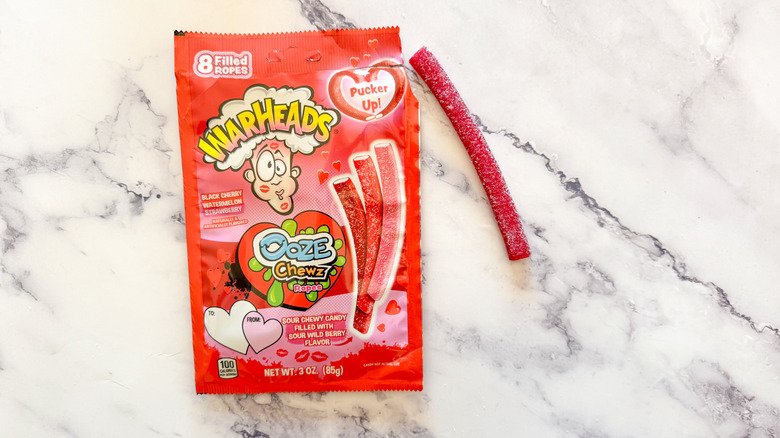 Warheads Ooze Chewz Ropes candy on marble background