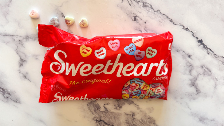 Sweethearts candy bag on marble background