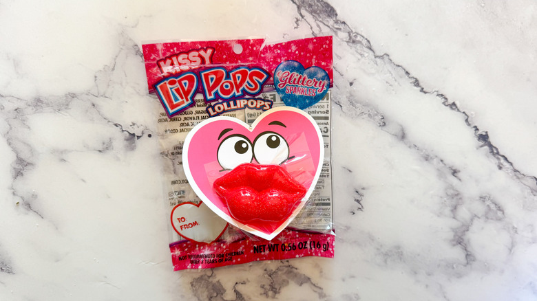 Kissy Lip Pop in wrapper on marble table