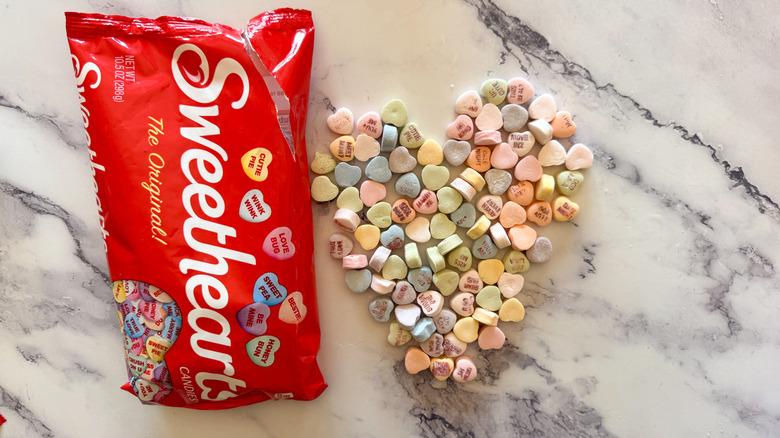 Sweethearts candy bag with heart-shaped candy on marble surface