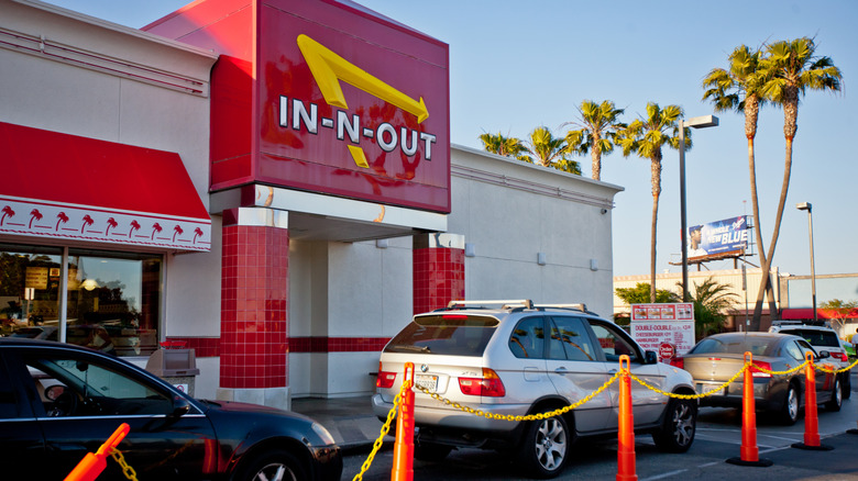 An In-N-Out burger location with a line of cars outside