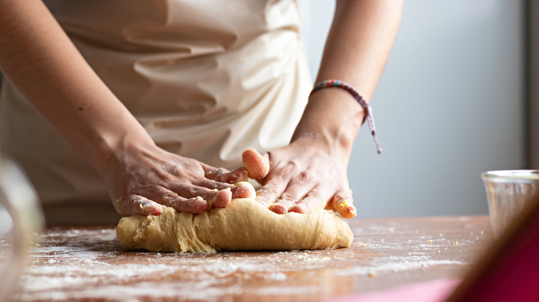 Mixing dough on counter with hands