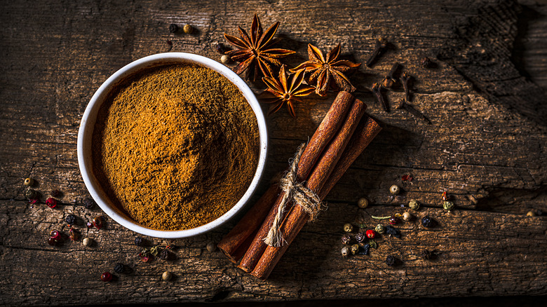 Warming spices on wooden background