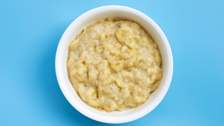 Mashed bananas in blue bowl