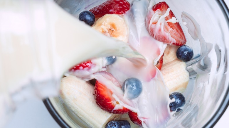 pouring almond milk into blender