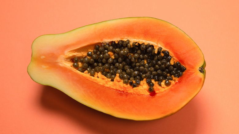 Papaya on pink background