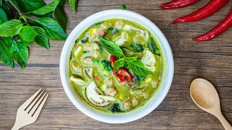 table with green curry bowl