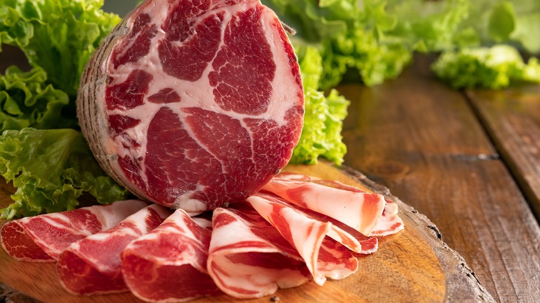 slices of capocollo on cutting board