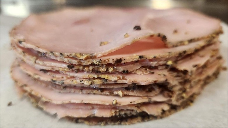 stack of sliced black peppered ham
