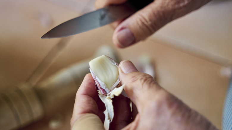 Peeling fresh garlic with a knife