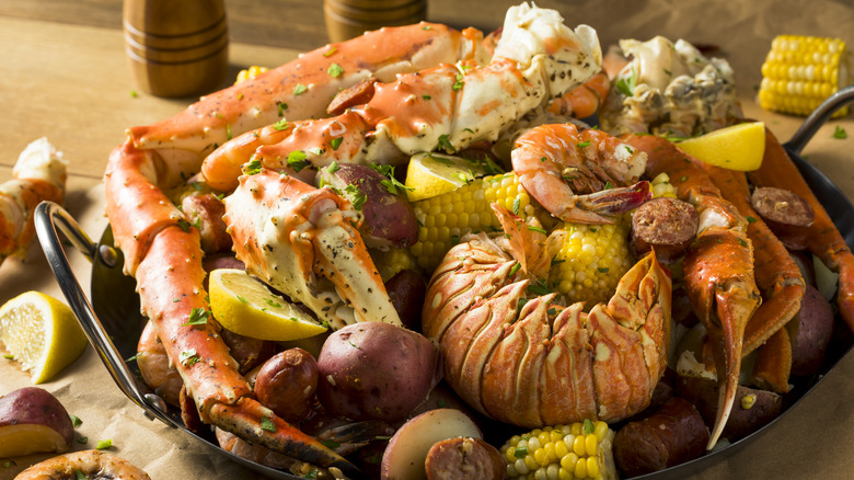 a mixed seafood boil with corn and lemons