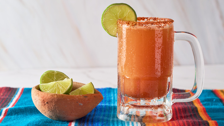 michelada in a mug with lime wheel