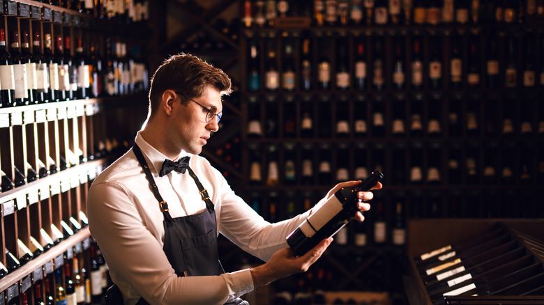 Man studying wine bottles