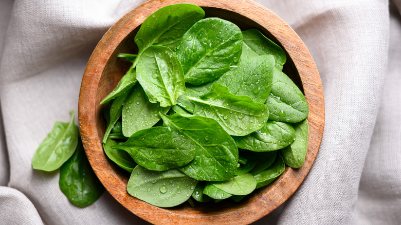 a bowl of fresh spinach leaves