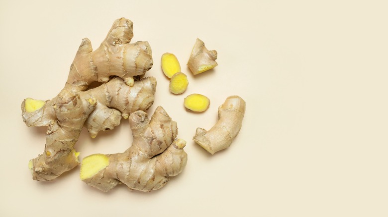 Sliced ginger on beige background