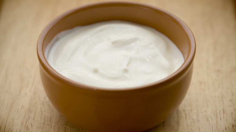 Sour cream in brown bowl