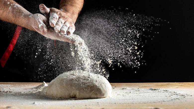 Flouring pizza dough