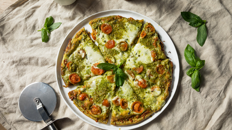 Pesto pizza on table