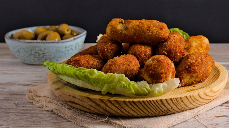 pile of croquetas with lettuce leaf