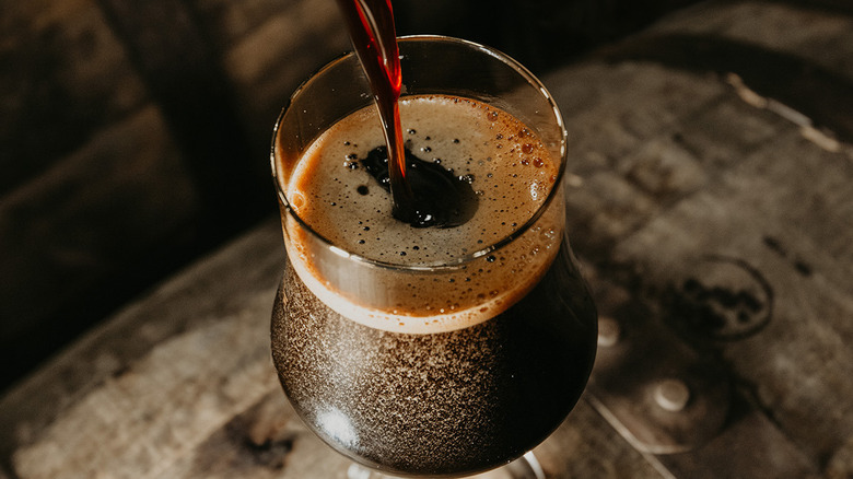 Pouring a dark beer