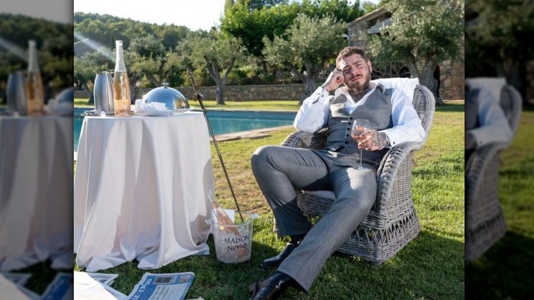 Post Malone sitting with wine