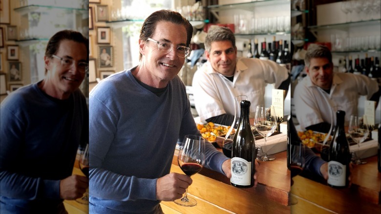 Kyle MacLachlan holding wine