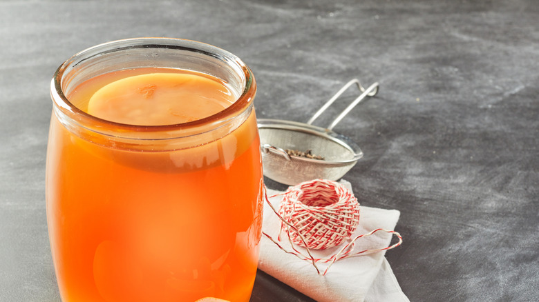 Orange cocktail and strainer