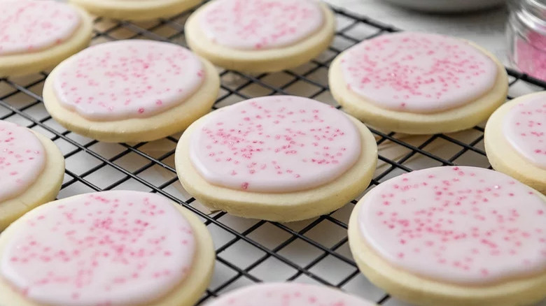 Pink sugar cookies on rack