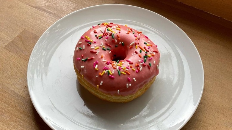 A pink sprinkle doughnut