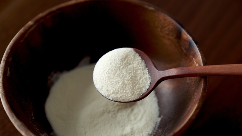 Milk powder in wooden bowl