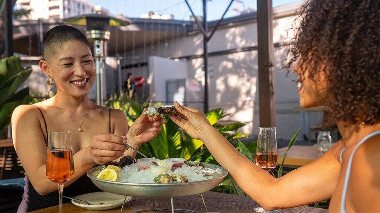 Couple eating oysters at Messhall LA