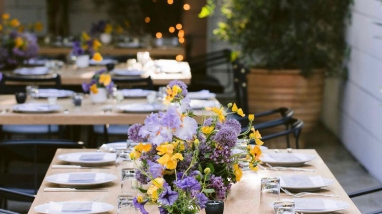 Ysabel LA outdoor tables with flowers 