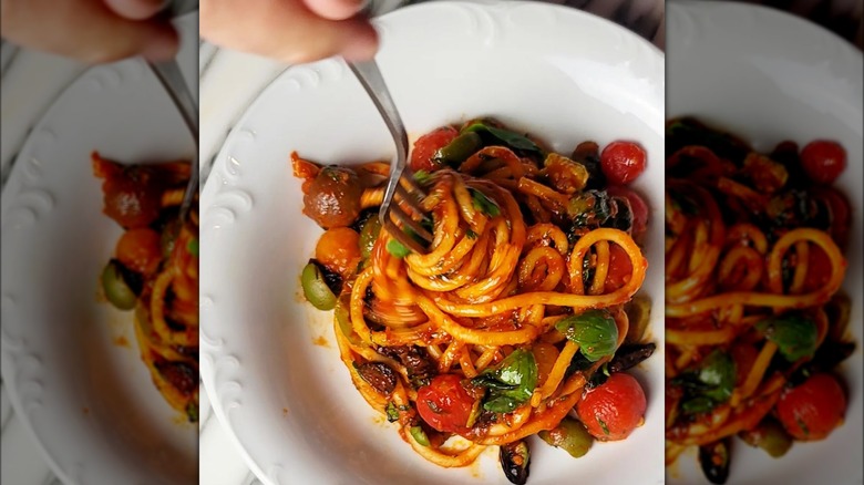 Puttanesca pasta with fork 